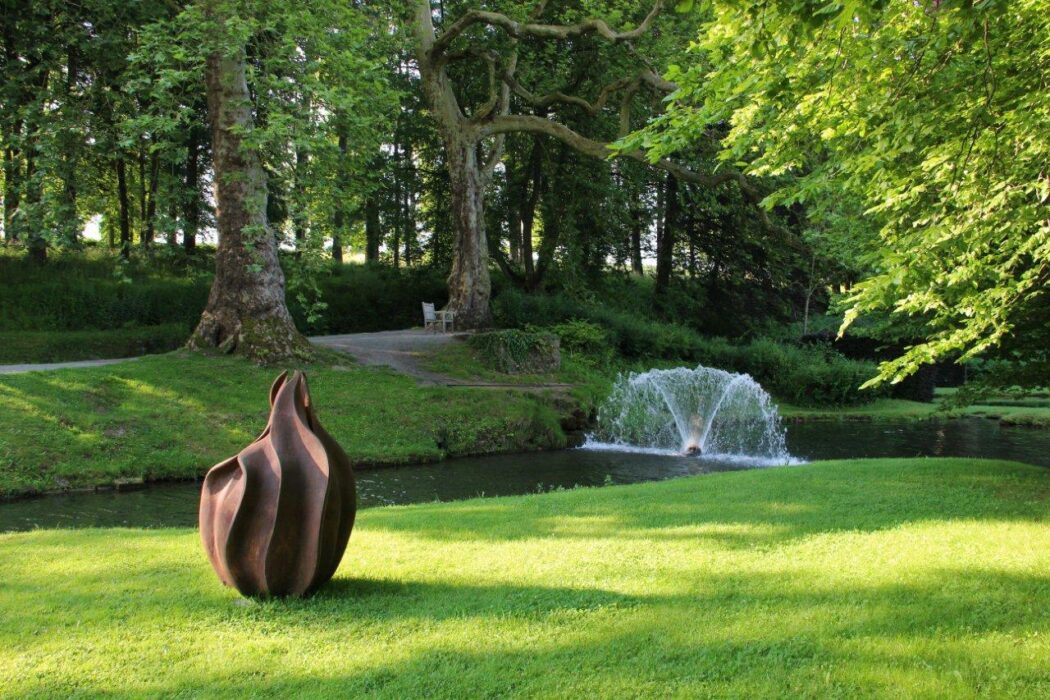 A garden sculpture entitled Physalis by Anne Curry shown in the gardens of Annevoie in Belgium