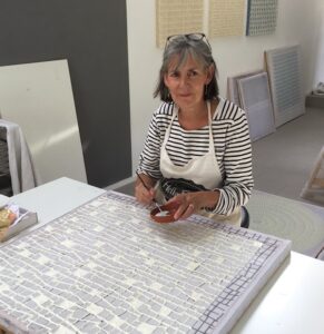 Paper artist Gill Wilson at work in her studio
