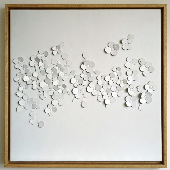 White leather artwork by Louise Heighes of blossom petals mounted in a frame