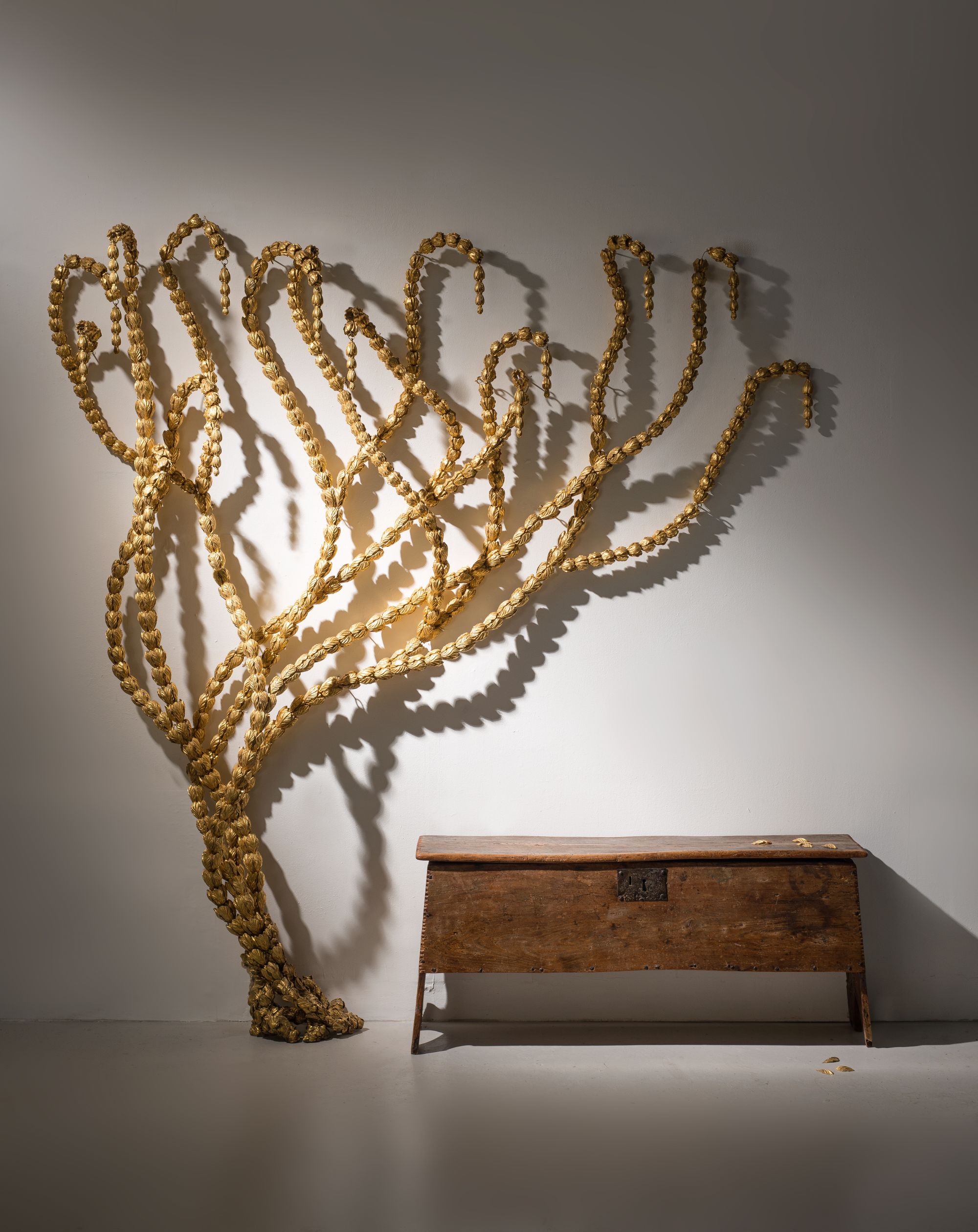 Vine by Sophie Coryndon a wall sculpture comprising gilt husks, formerly exhibited at the Royal Academy of Arts in London