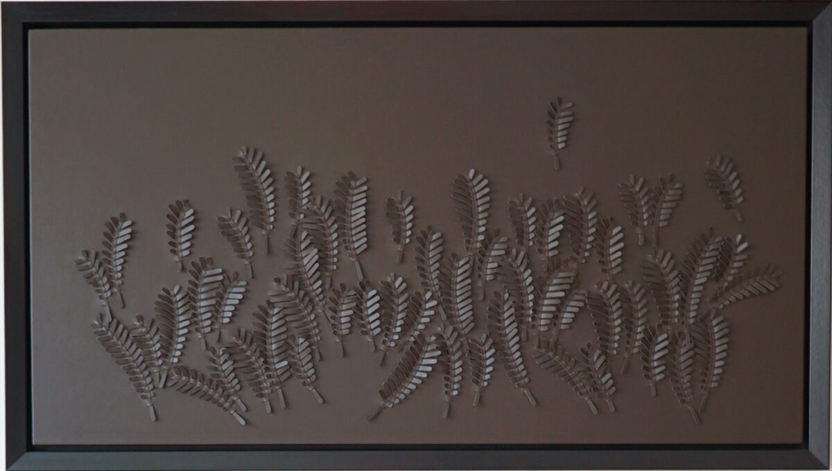 A khaki leather artwork of ferns by artist Louise Heighes